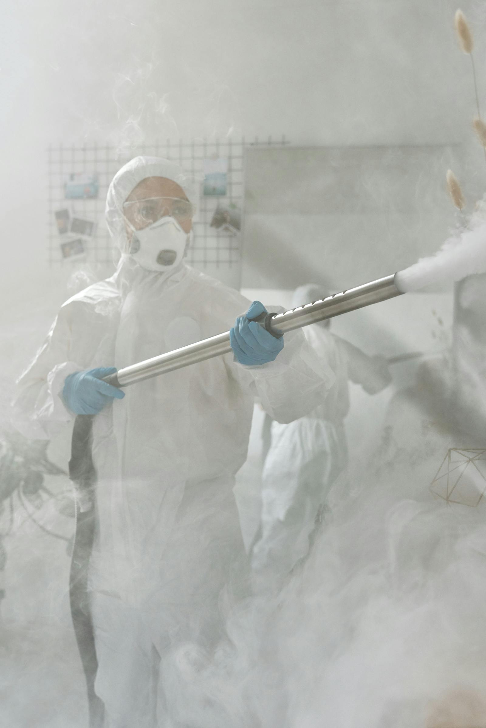 Protective-suit worker disinfecting an indoor room